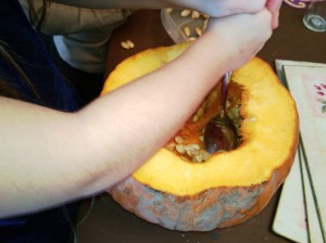 It's a slother pumpkin. It feels really cold. There are lots of stringy bits, they look like messy hair.