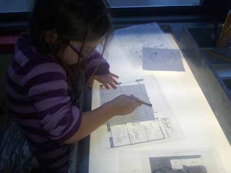 light table with maps and plans