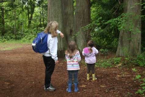 children and teacher look at trees