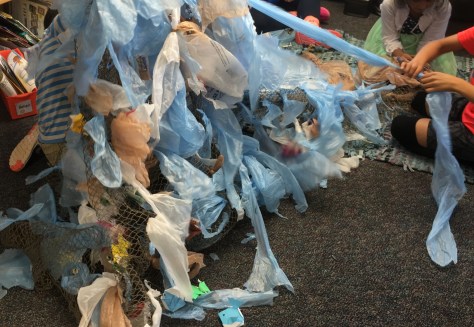 tying blue bags to the net