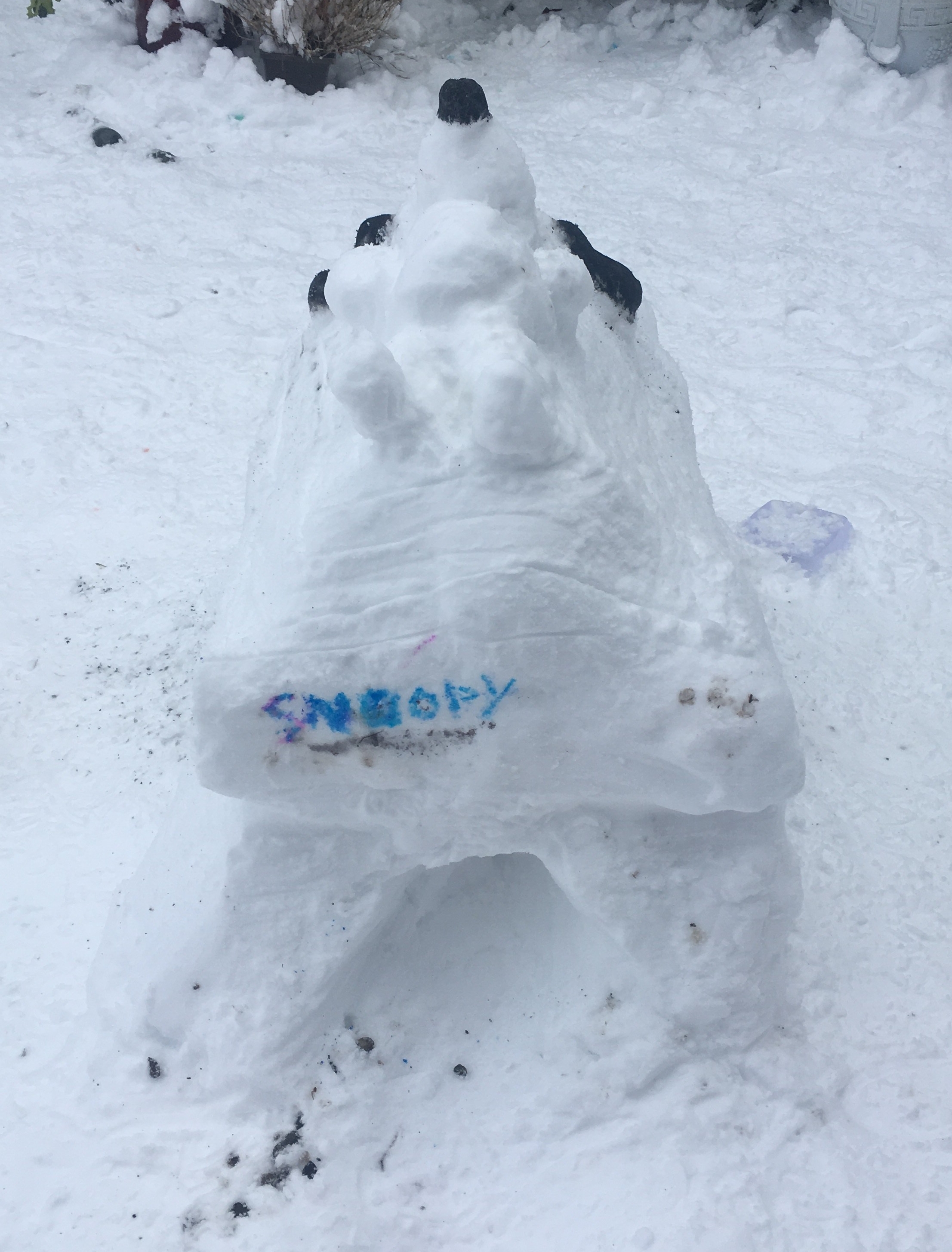 snow sculpture snoopy on kennel