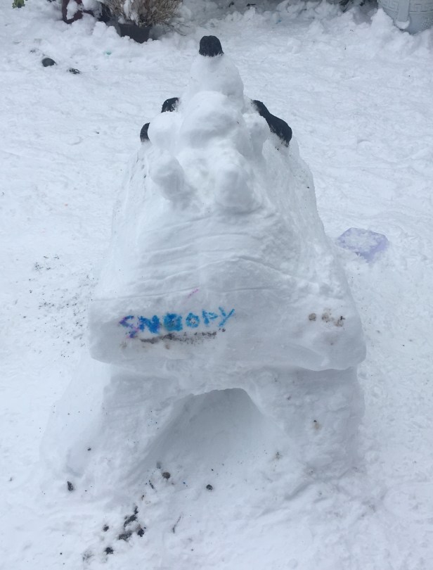 snow sculpture snoopy on kennel